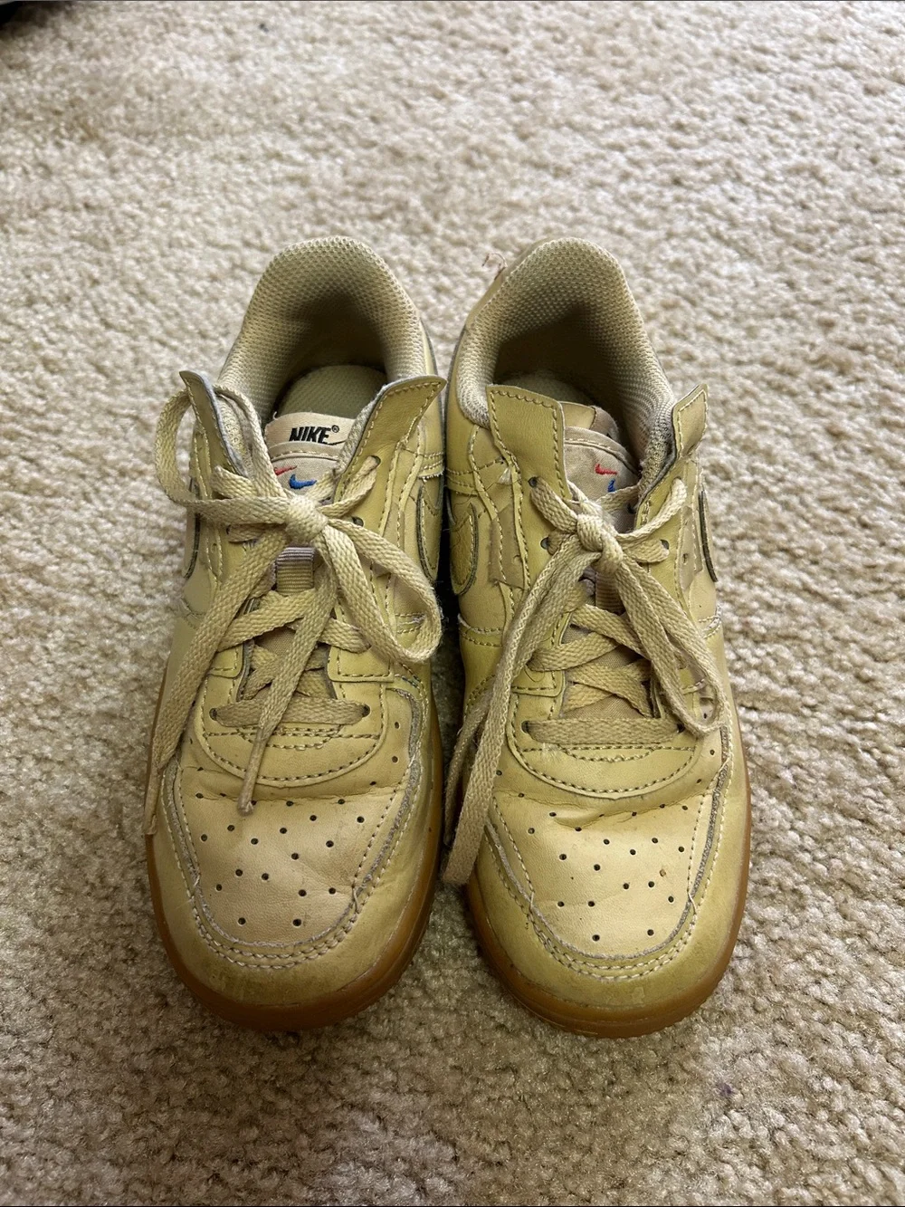 Nike Kids beige/tan sneakers.